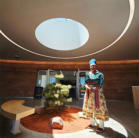 Interior photo of skylight, earth, and woman